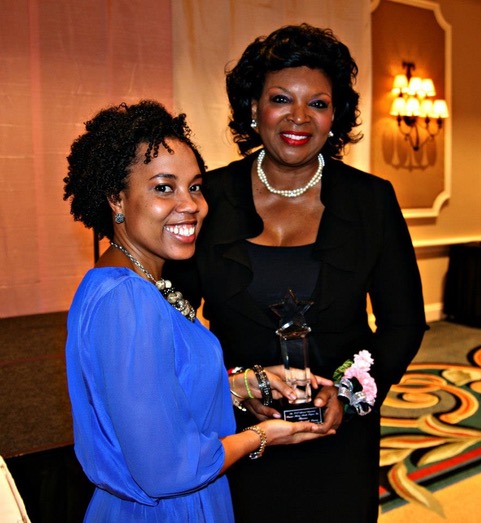 An honoree receiving her award at an AAWHMP ceremony